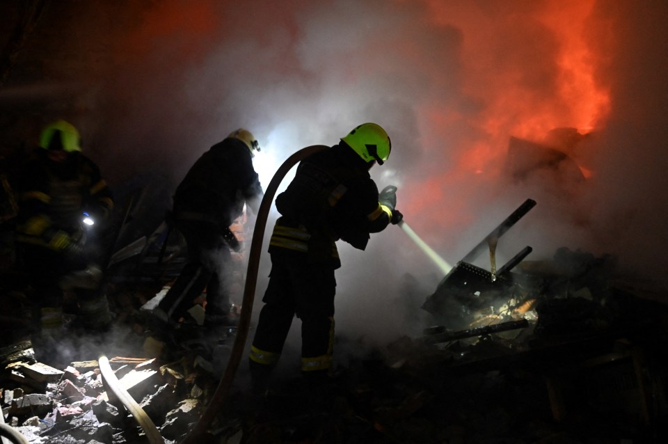 Firefighters work to extinguish a fire on a destroyed building in the Ukrainian city