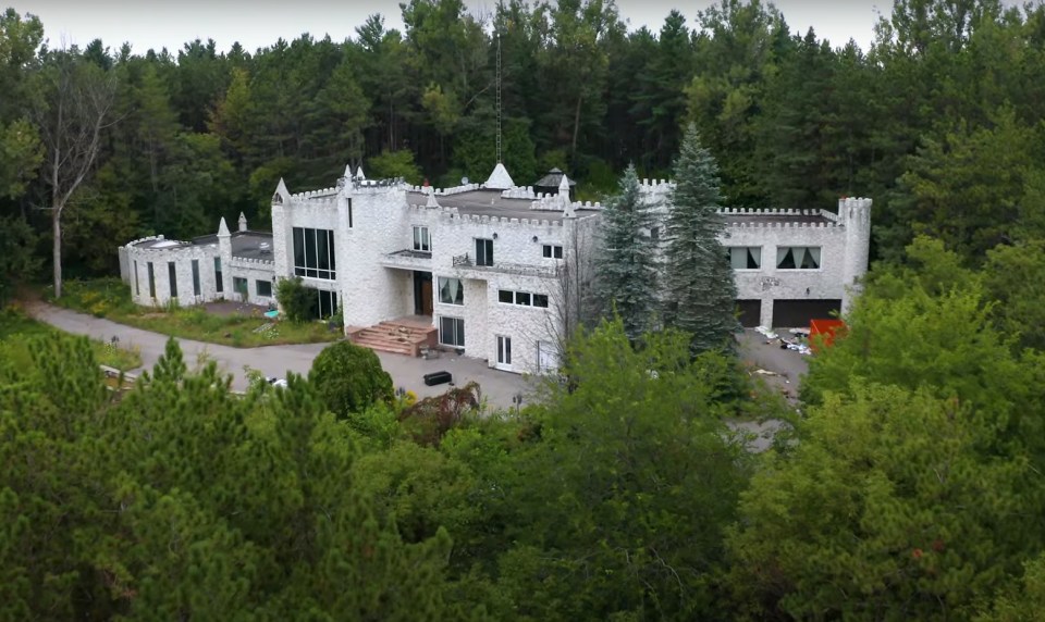 An abandoned castle mansion sits deep in the Canadian forest