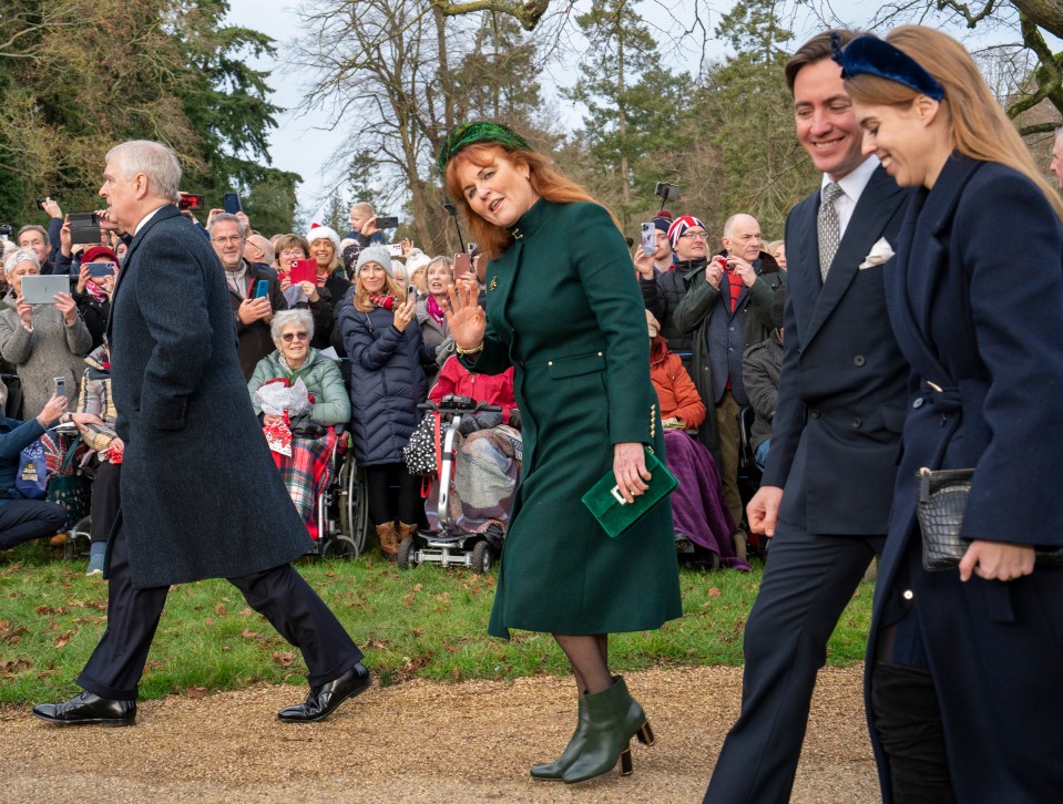 Sarah Ferguson waves to crowds while walking to church on Christmas Day with Prince Andrew