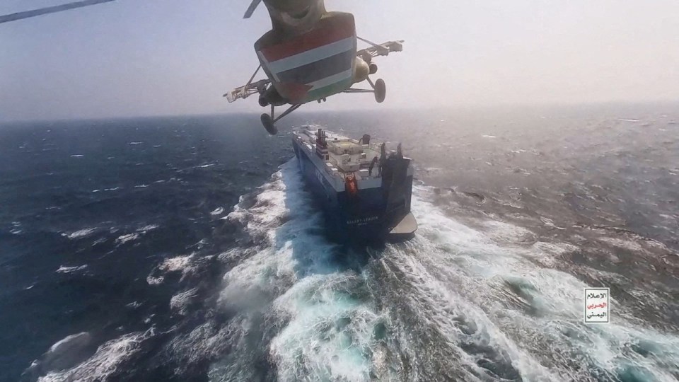 A Houthi military helicopter flies over the Galaxy Leader cargo ship in the Red Sea in November