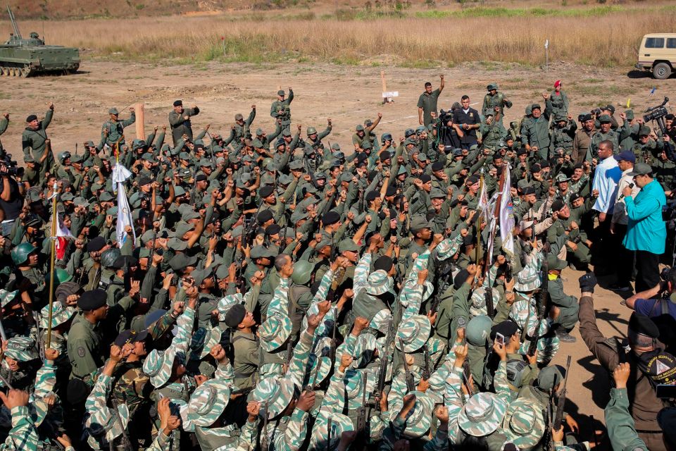 Maduro (R) speaking to troops during military exercises at Fort Paramacay in Naguanagua in 2019