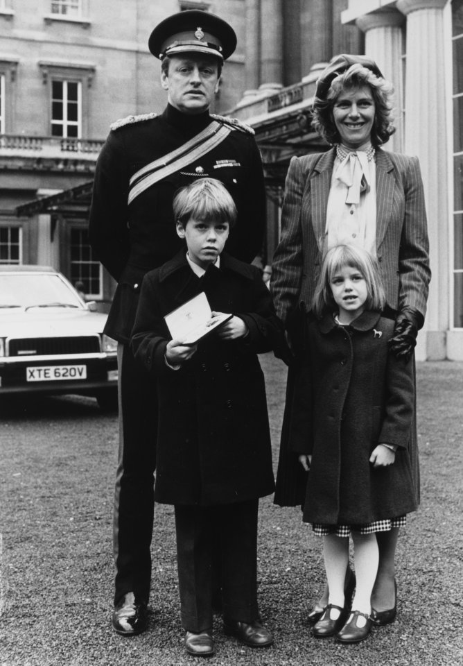 Andrew colllects his OBE from the Queen at Buckingham Palace with wife Camilla, son Tom and daughter Laura