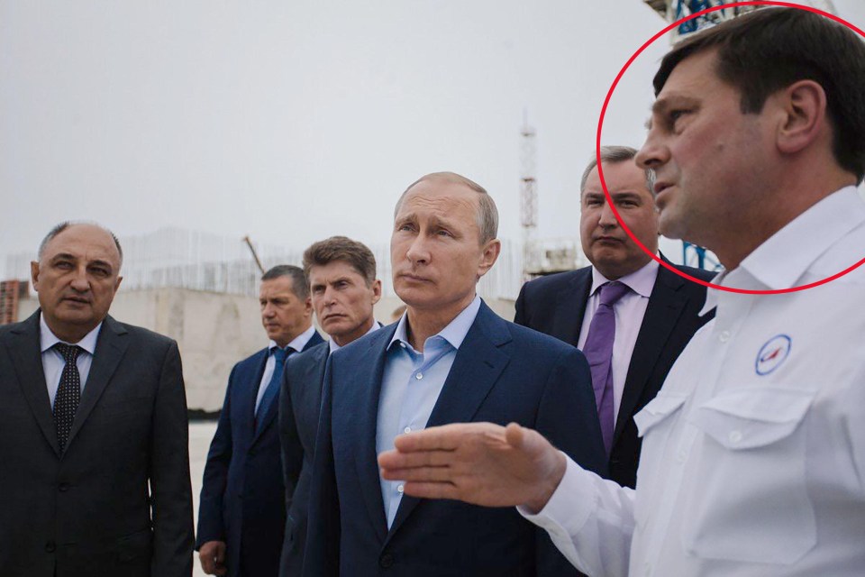 Frolov - wearing the white coat - pictured with Vladimir Putin