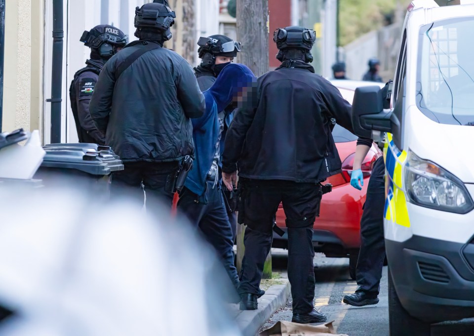 Cops detaining the suspect yesterday afternoon