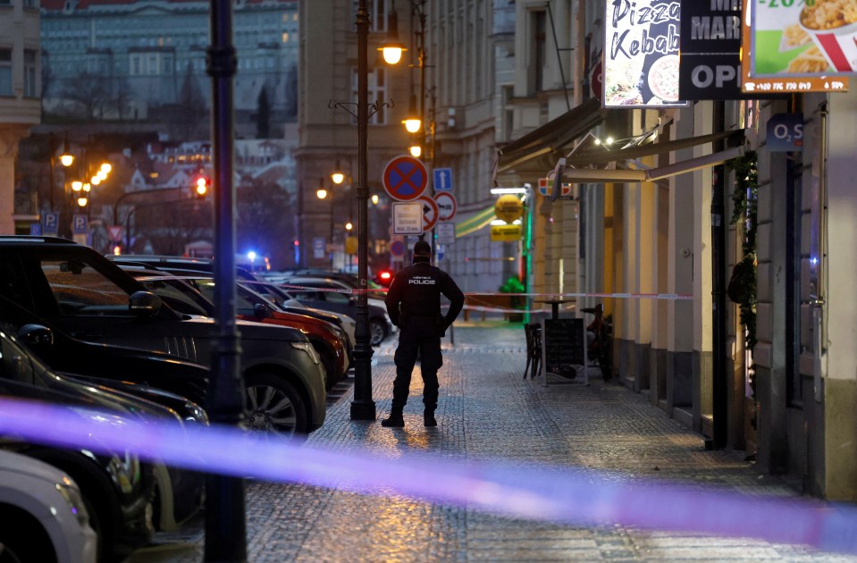 A police officer secures the area following the deadly shooting