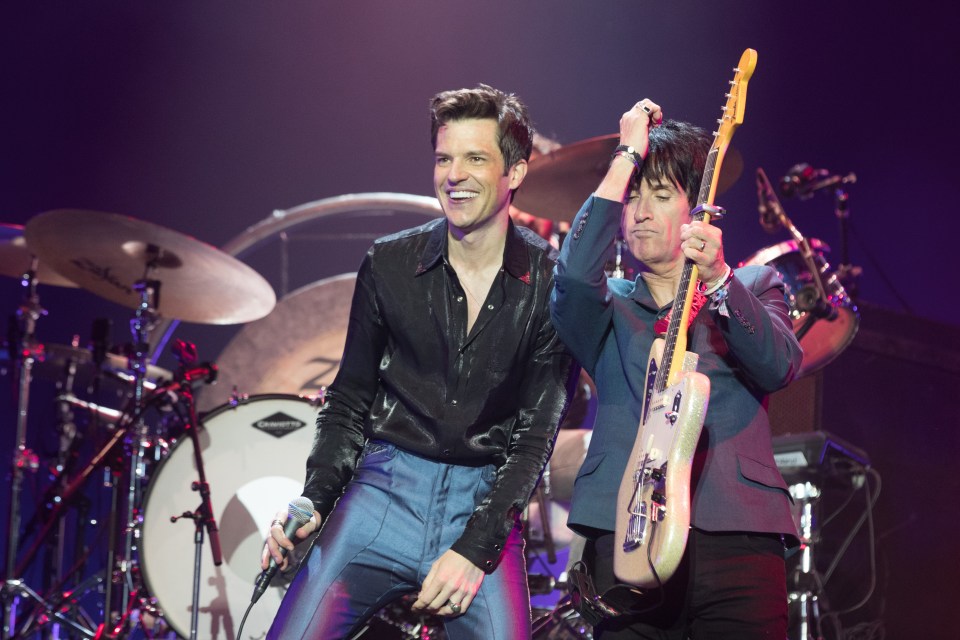 Flowers on stage at Glastonbury with former Smiths guitarist Johnny Marr