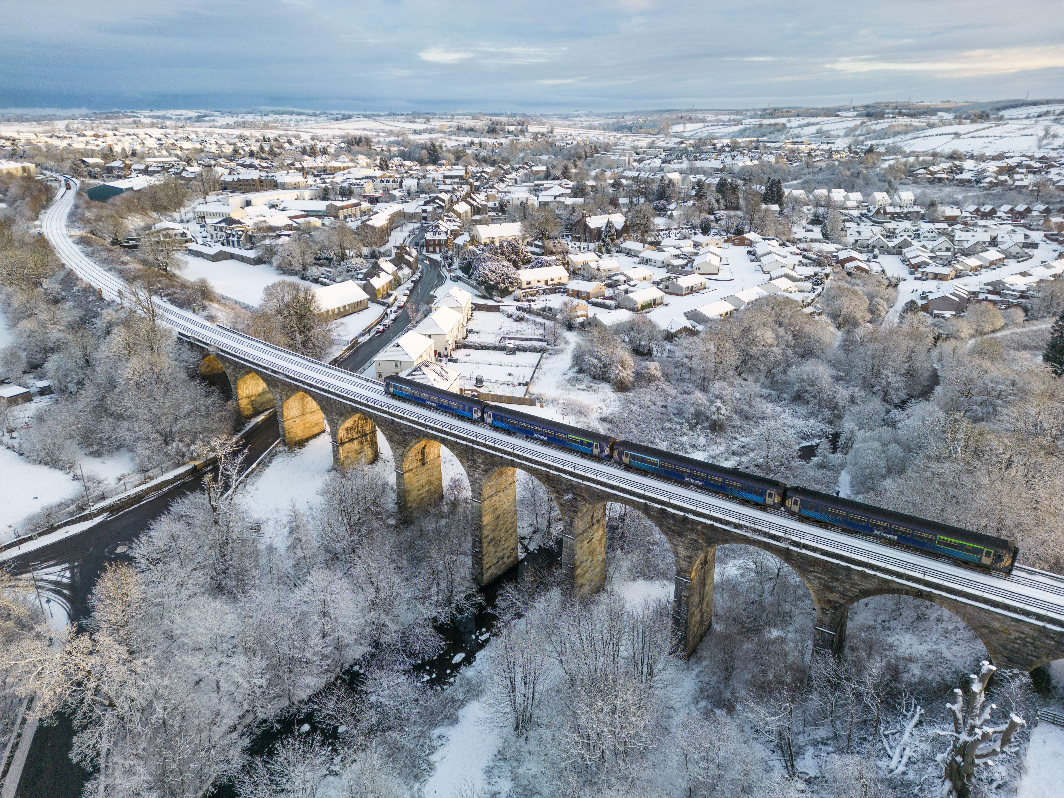 A train crosses the Viaduct in Stewarton, Ayrshire as swathes of Britain woke up to snow