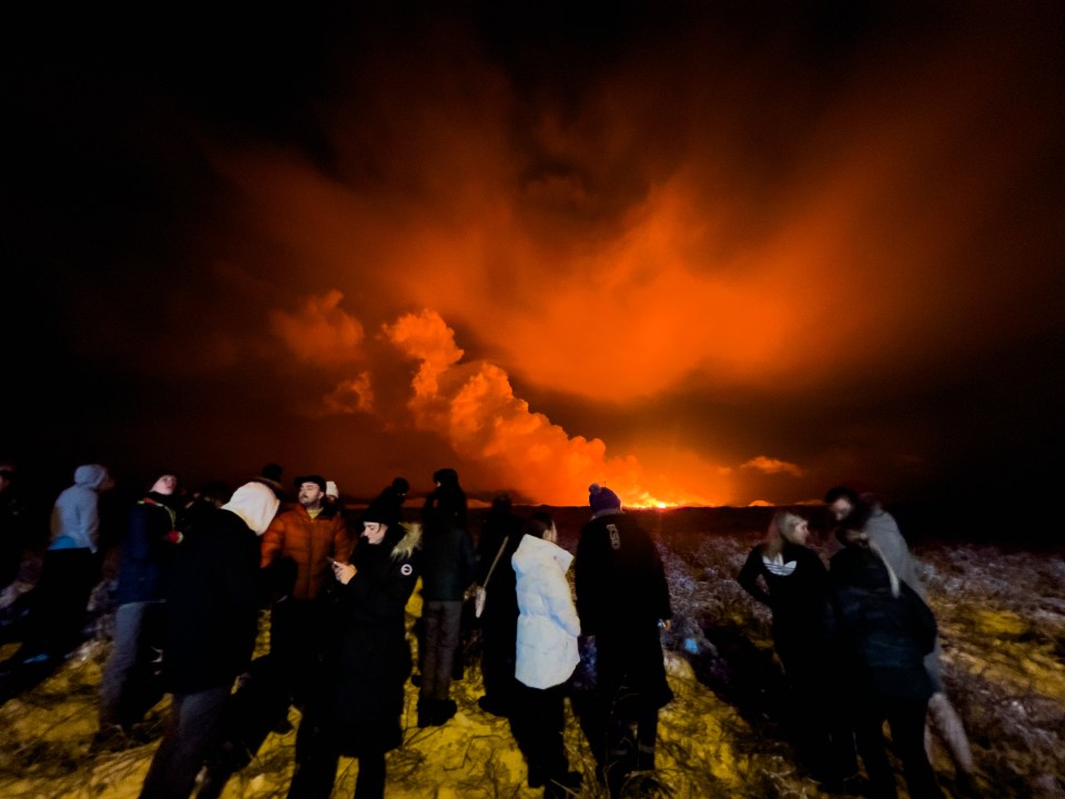 Residents watch on as the volcano erupts