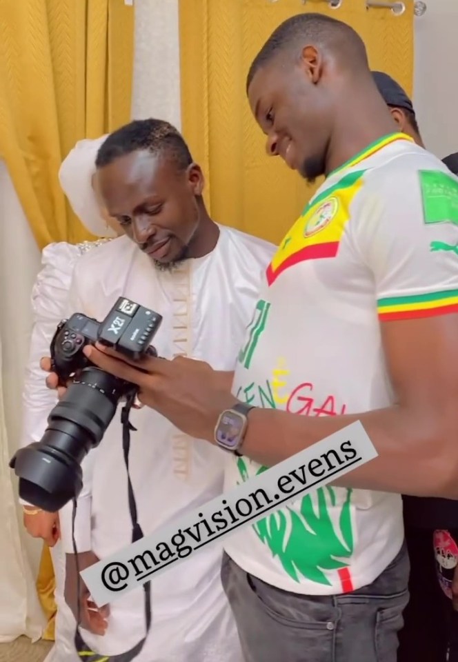 Mane taking a look at his wedding pictures