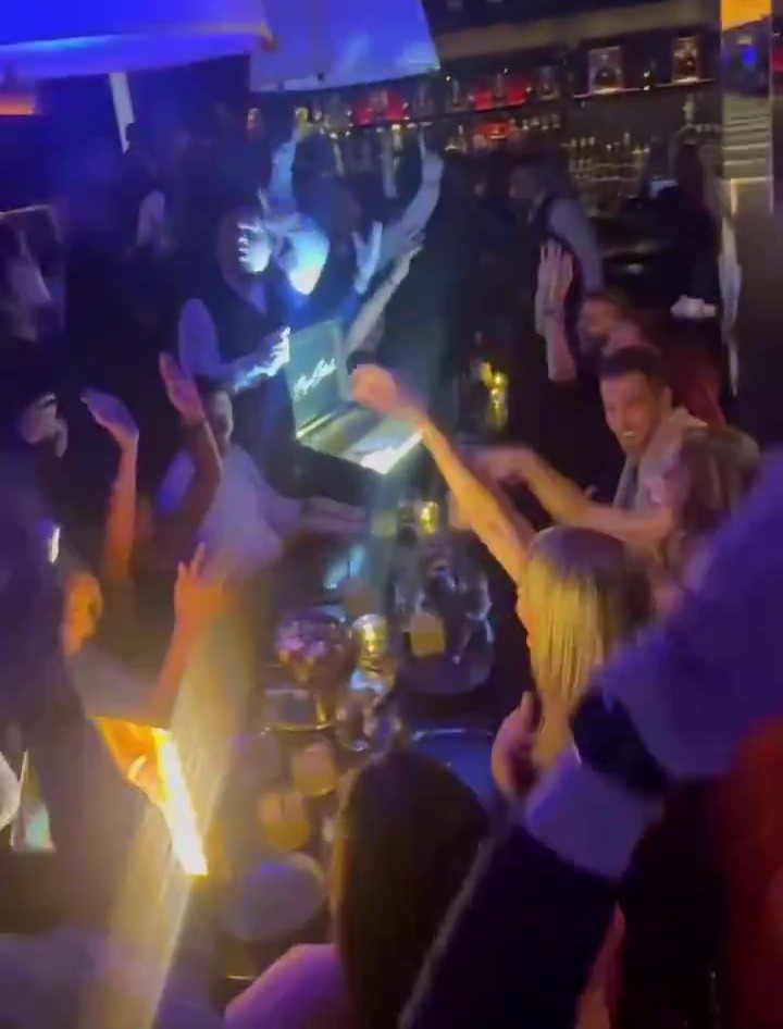 Messi and people on his table were filmed throwing their hands up in celebration