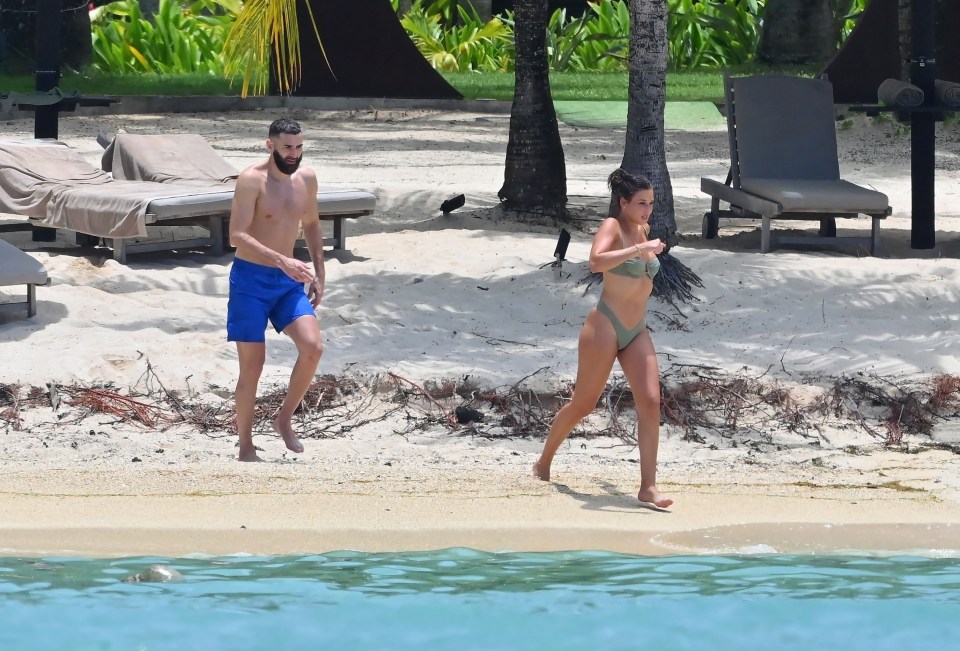 The couple prance into the ocean