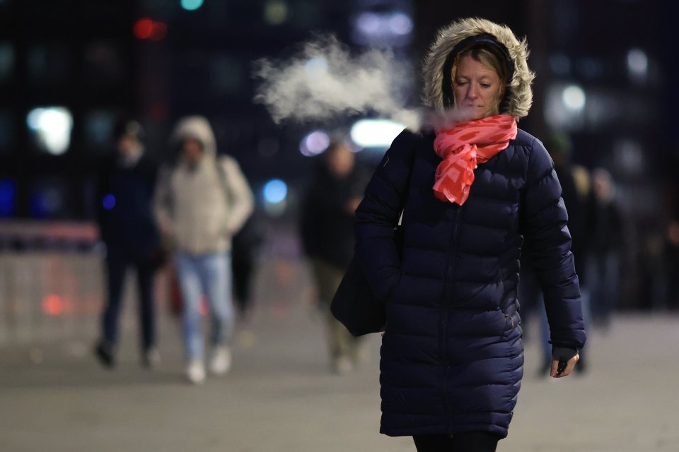 A commuter on London Bridge in the capital was wrapped up to face the cold this morning