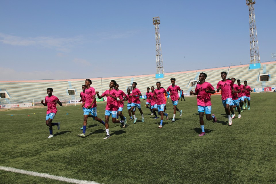 Footballers warm up at the brand new national stadium