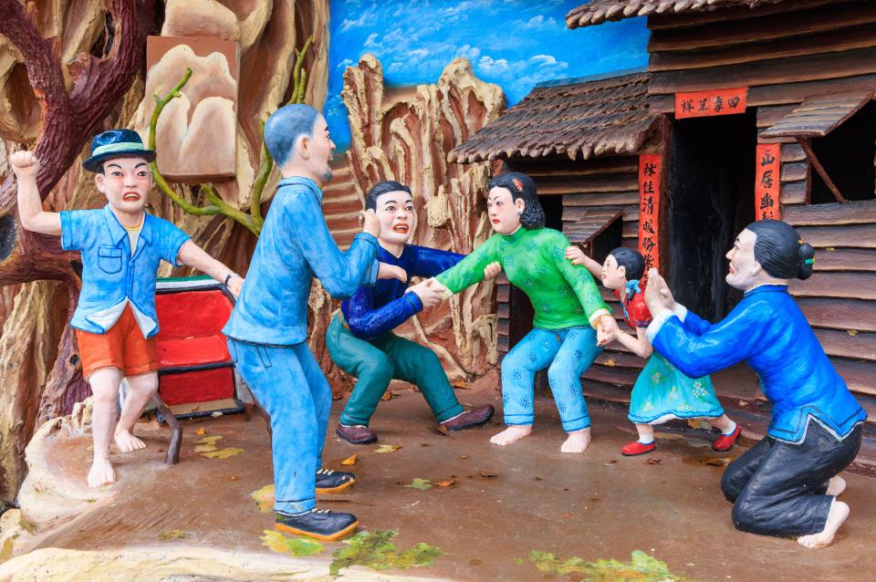 A model at the theme park shows people fighting in a village