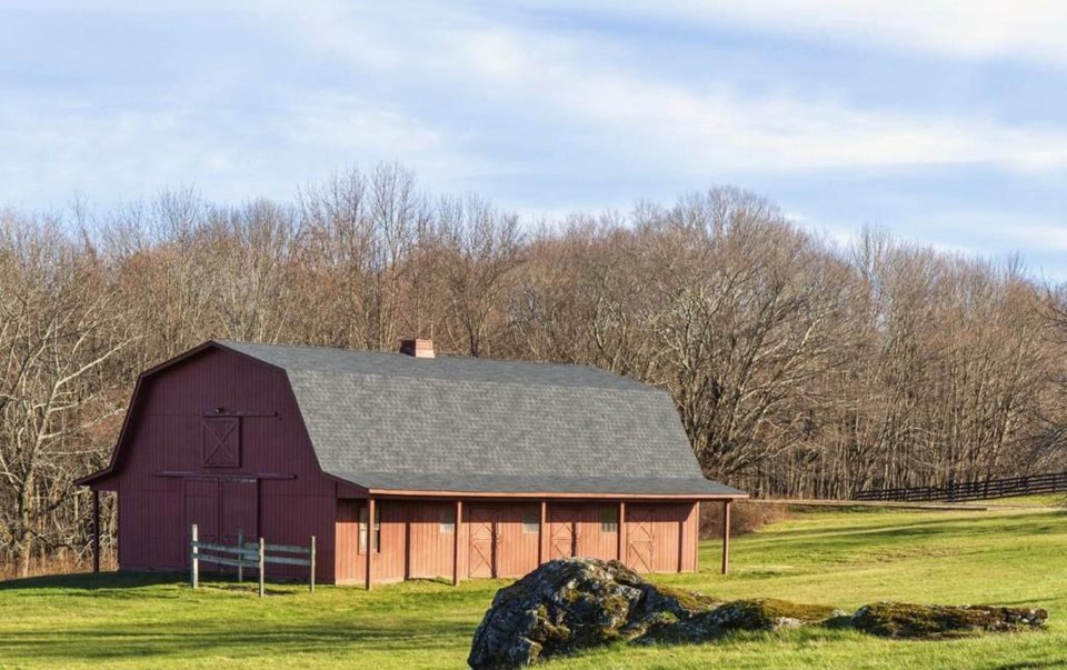 A six-stall horse barn stable yard stands in the garden