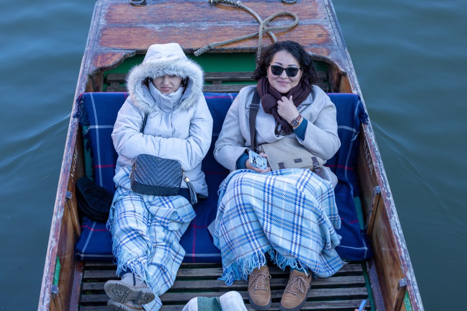 Two women wrap up on the River Cam in Cambridge on a freezing cold Saturday morning