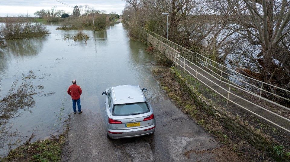 A driver stuck on a flooded road  in Cambridgeshire on Sunday morning after the New Bedford River burst