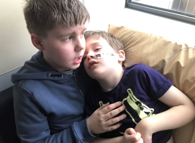 Freddie (left), cradling Samuel just a few days before he slipped into a coma