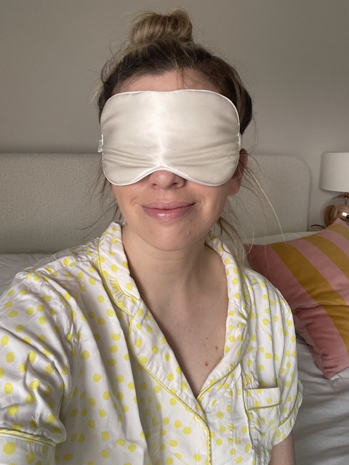 Woman wearing a sleep mask and pajamas.