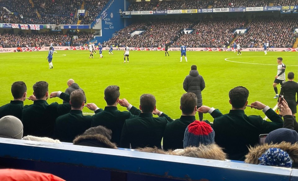 A group of movie promoters brush their teeth in the stands at Stamford Bridge