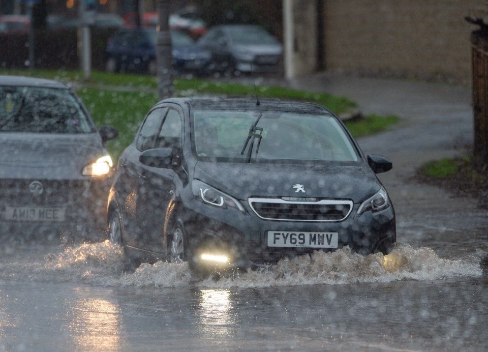 A driver braves the flooded A726 near Paisley in Glasgow