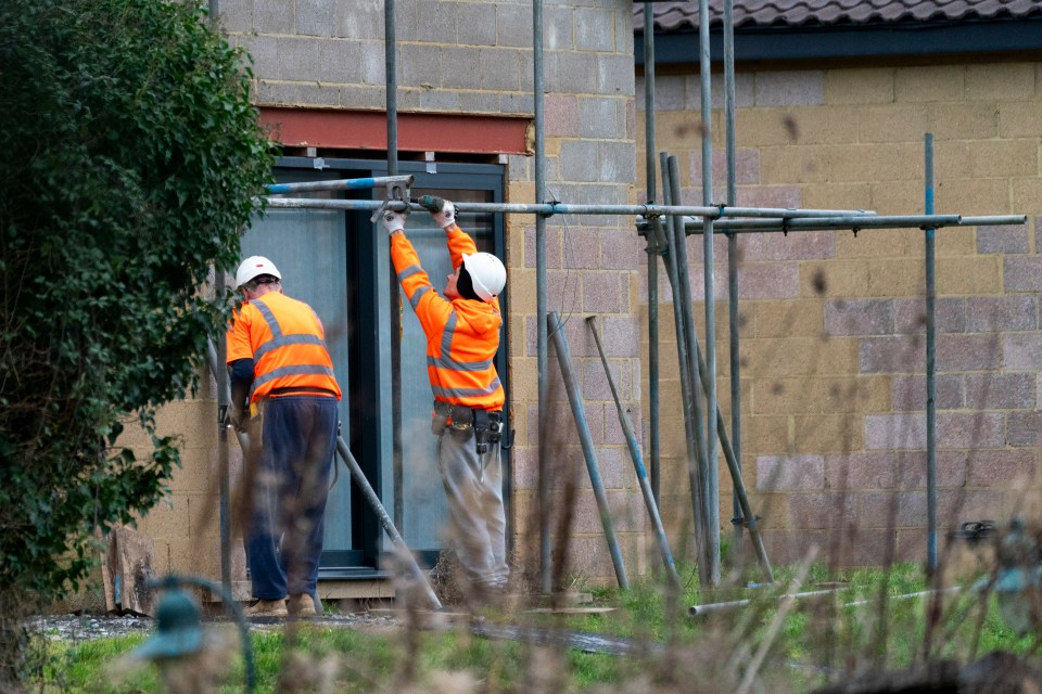 Scaffolders start to place a frame around the spa before the demolition starts