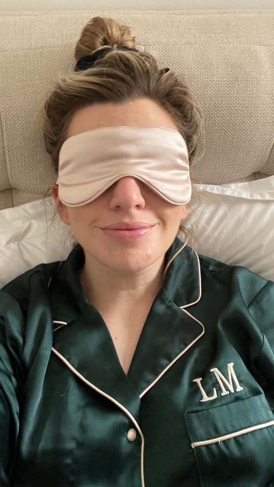 Woman wearing a sleep mask and pajamas.