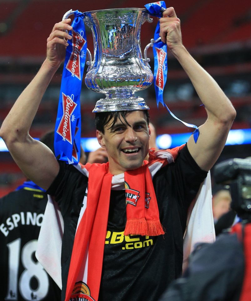 Austrian ace Paul Scharner proudly holds aloft the FA Cup at Wembley