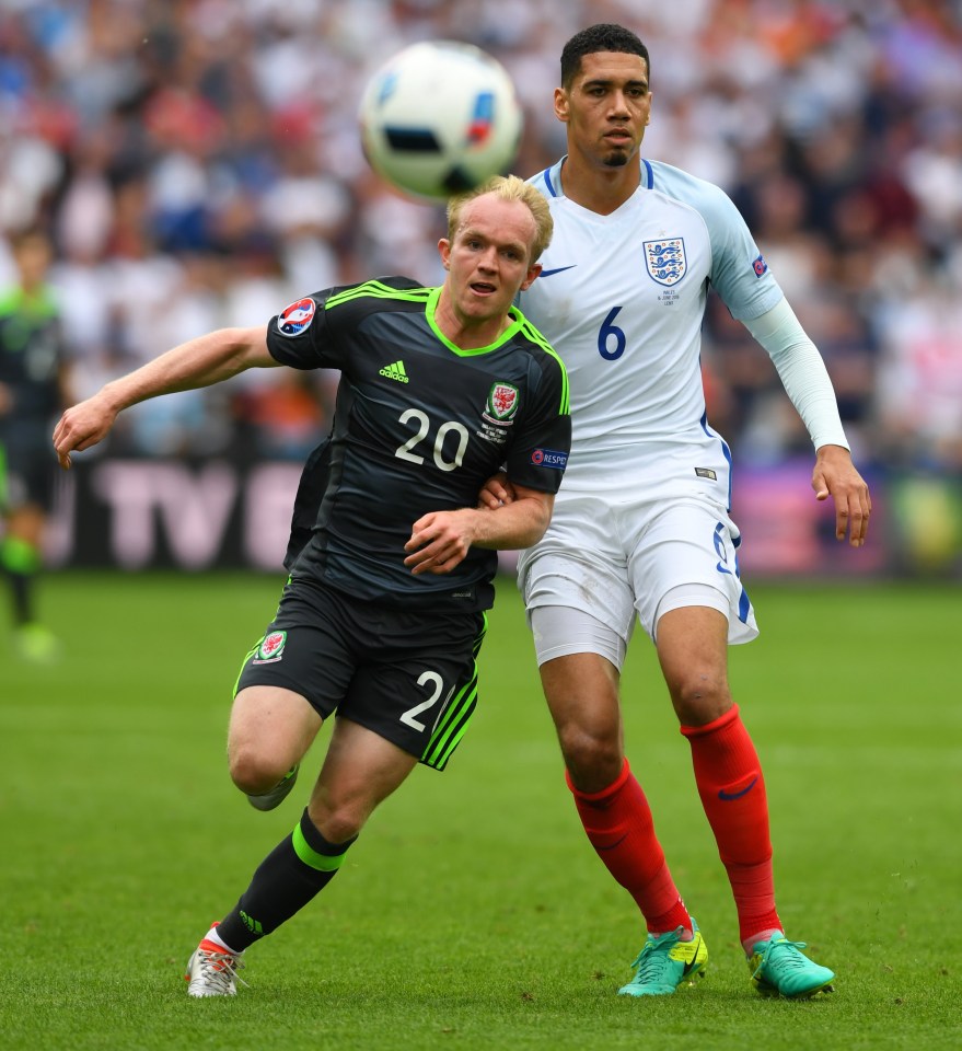 LENS, FRANCE - JUNE 16:  Chris Smalling of England challenges Jonny Williams of Wales during the UEFA Euro 2016 Group B match between England and Wales at Stade Bollaert-Delelis on June 16, 2016 in Lens, France.  (Photo by Stu Forster/Getty Images)