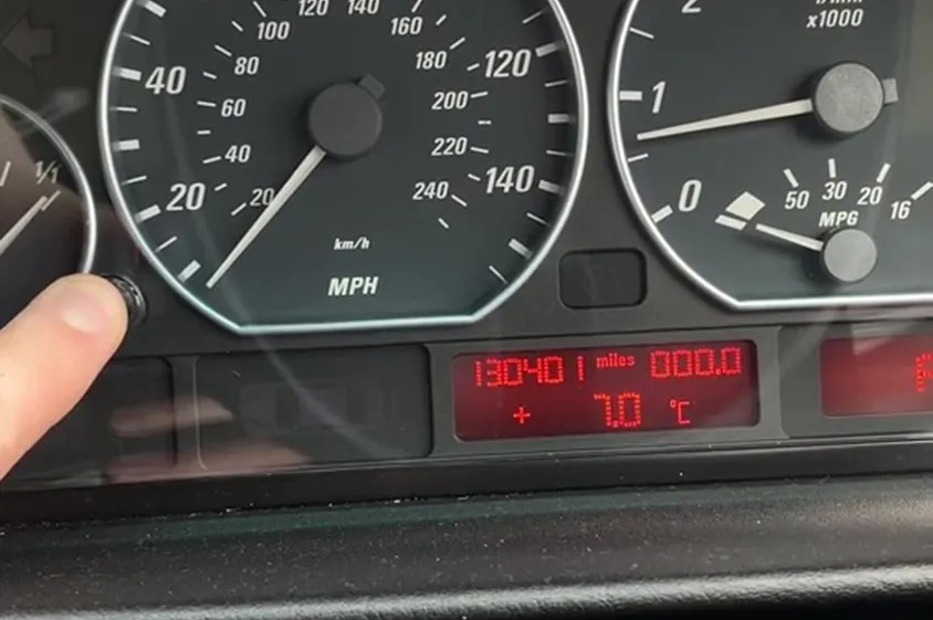 The trick involves pressing and holding your car's odometer reset button