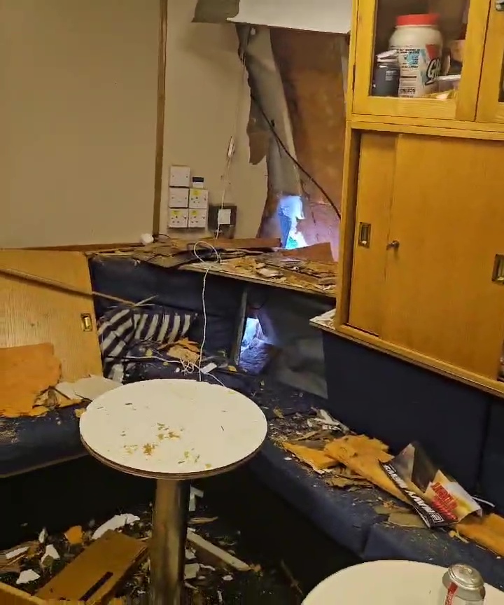 Smashed out cabinets, broken photo frames and other debris were seen scattered over the floor