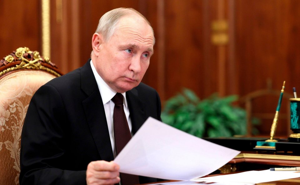 Vladimir Putin listens to Russian Railways CEO Oleg Belozerov during a face-to-face meeting at the Kremlin