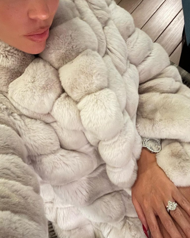 A diamond-encrusted watch sneaked out of her big fur coat