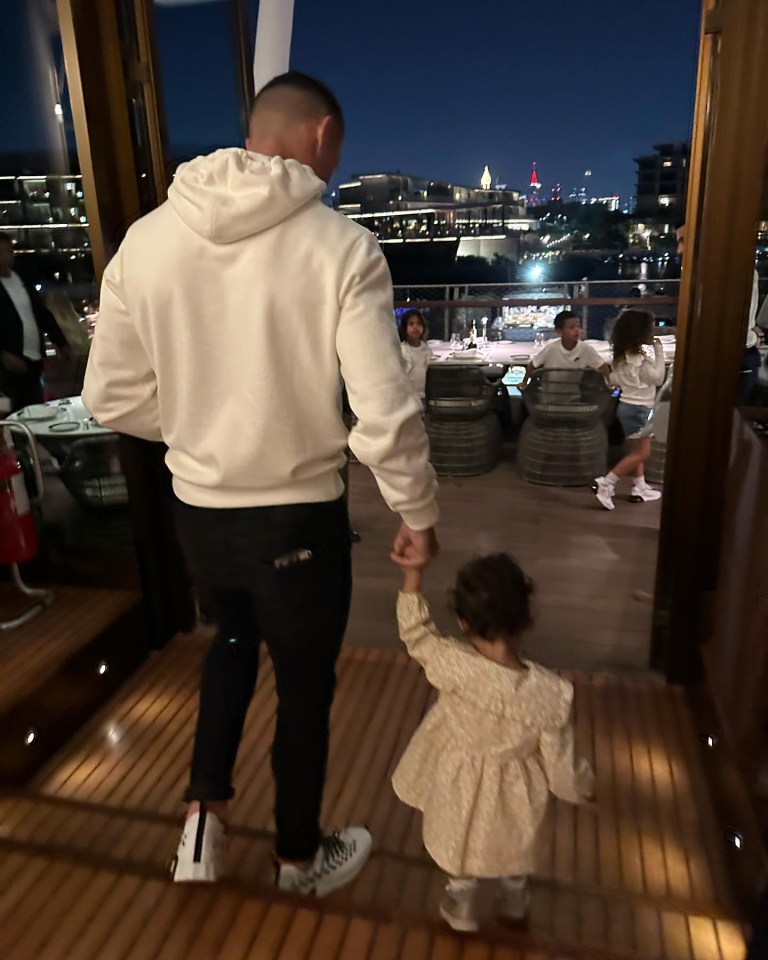 Ronaldo is pictured walking with one of his daughters