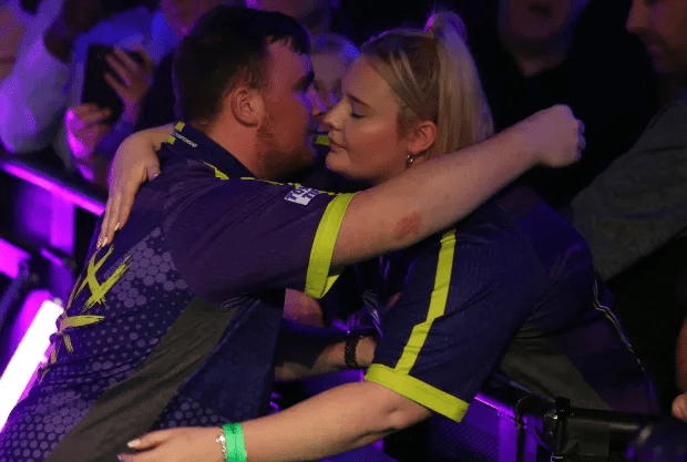 Littler hugged girlfriend Eloise following his victory