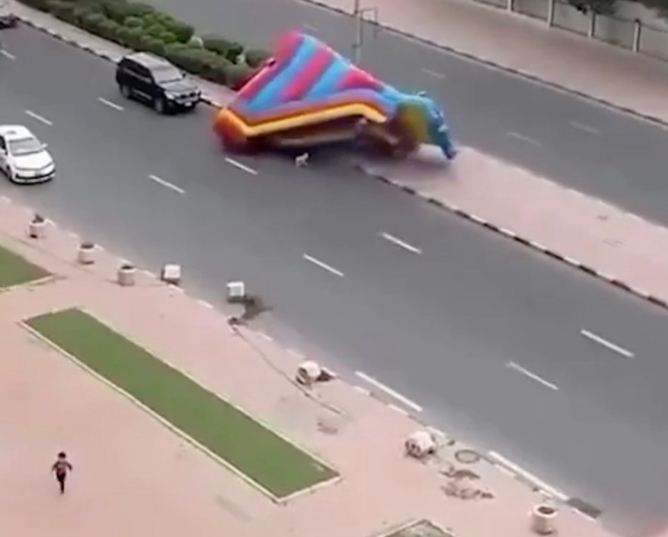 One child can be seen running on the pavement as a second child was dumped on the road