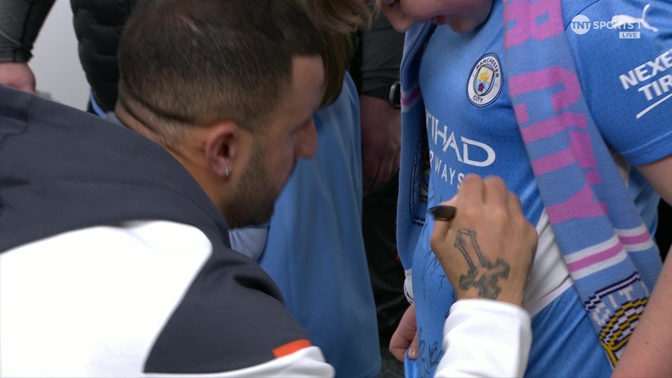 Kyle Walker signs a young fan's shirt as he arrives at St James' Park