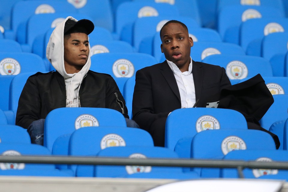 Marcus Rashford pictured watching from the stands alongside agent Dwaine Maynard