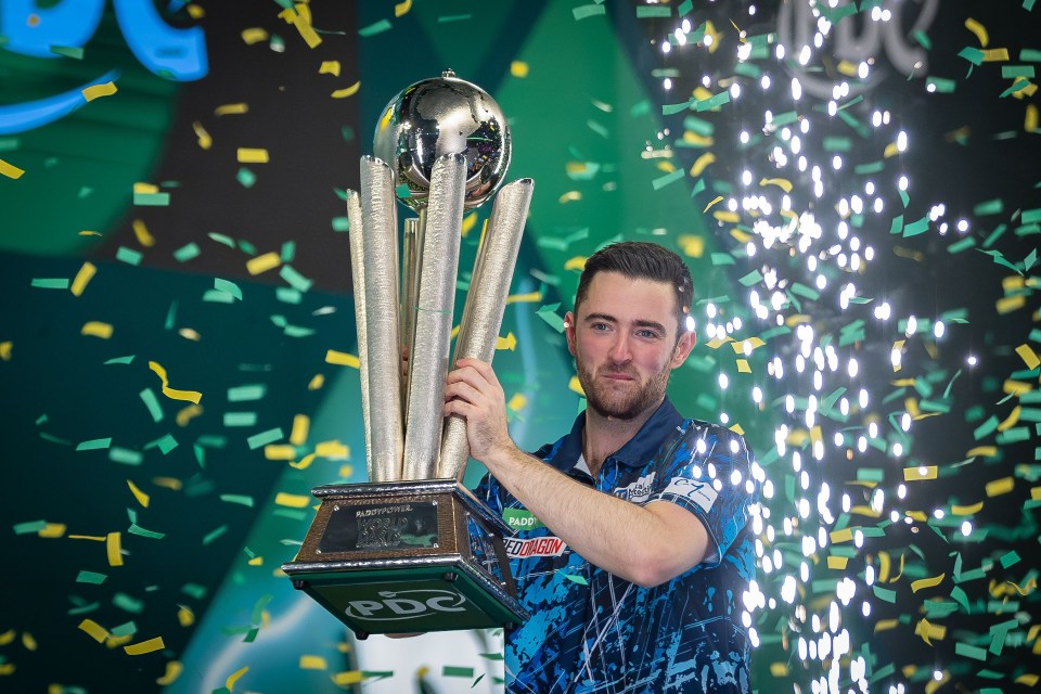 Luke Humphries lifts the Sid Waddell trophy after winning the 2024 Paddy Power Darts World Championship.