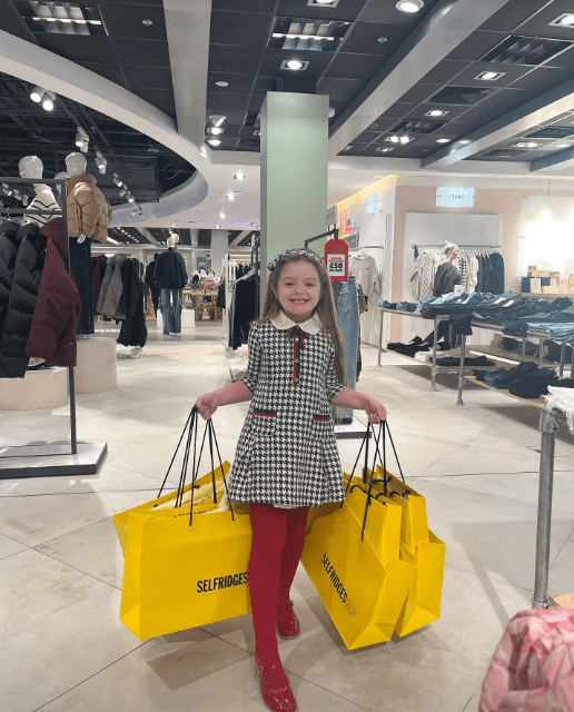 Valencia beamed as she was weighed down by Selfridges bags