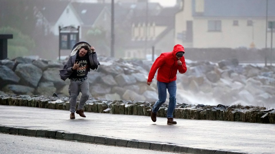 People walking in high winds at Salthill, Galway, during Storm Isha