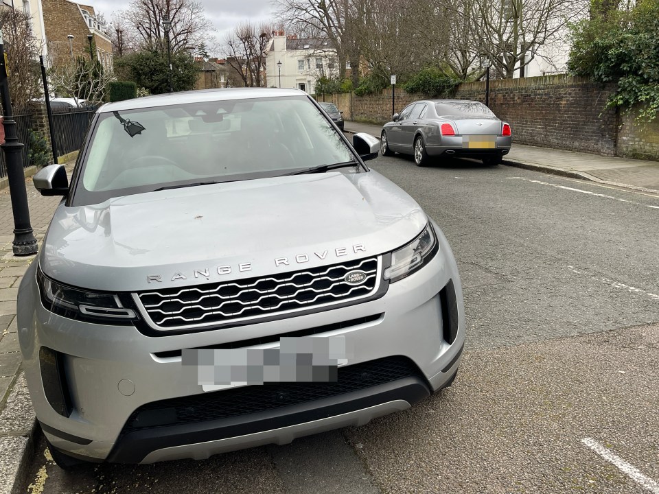 Luxury Range Rover parked up opposite a Bentley outside million-pound homes in Stockwell