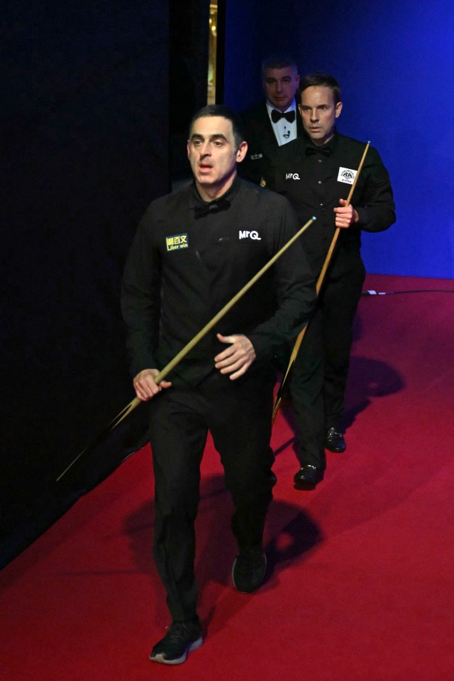 O'Sullivan leads the way as the rowing pair walk out at Alexandra Palace at the Masters