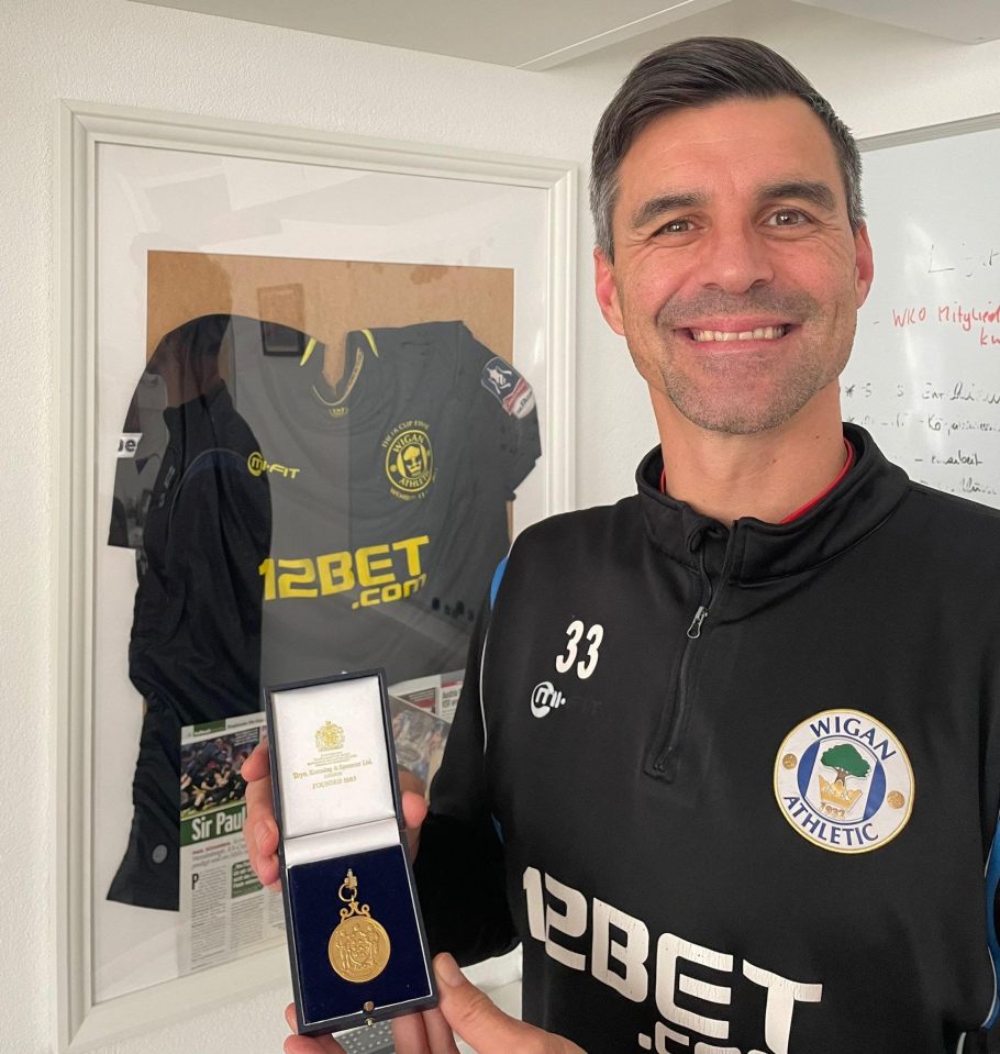 Paul Scharner shows off his 2013 FA Cup winners medal and shirt he wore that day against Manchester City at home in Austria