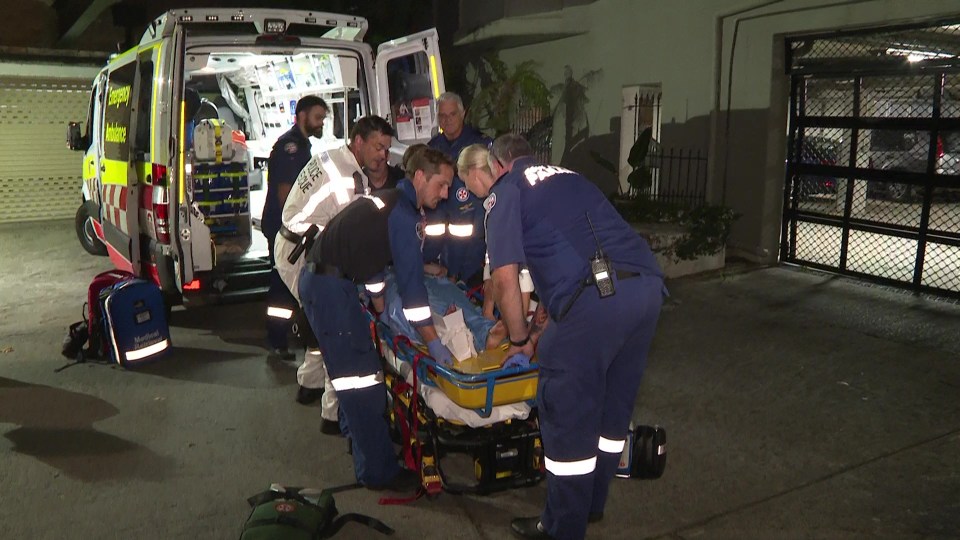 Paramedics carried the woman on a stretcher before putting her in the ambulance