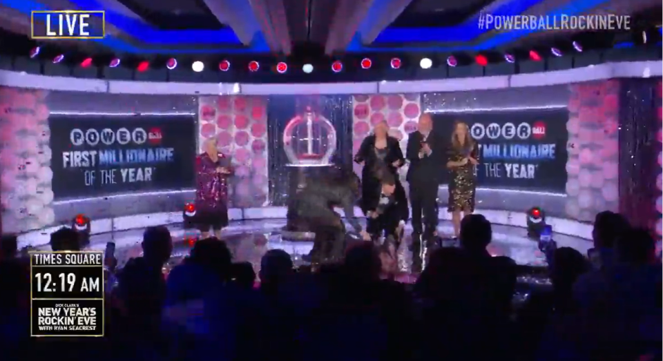 The lottery winner collapsed on stage as she was announced the first millionaire of the year