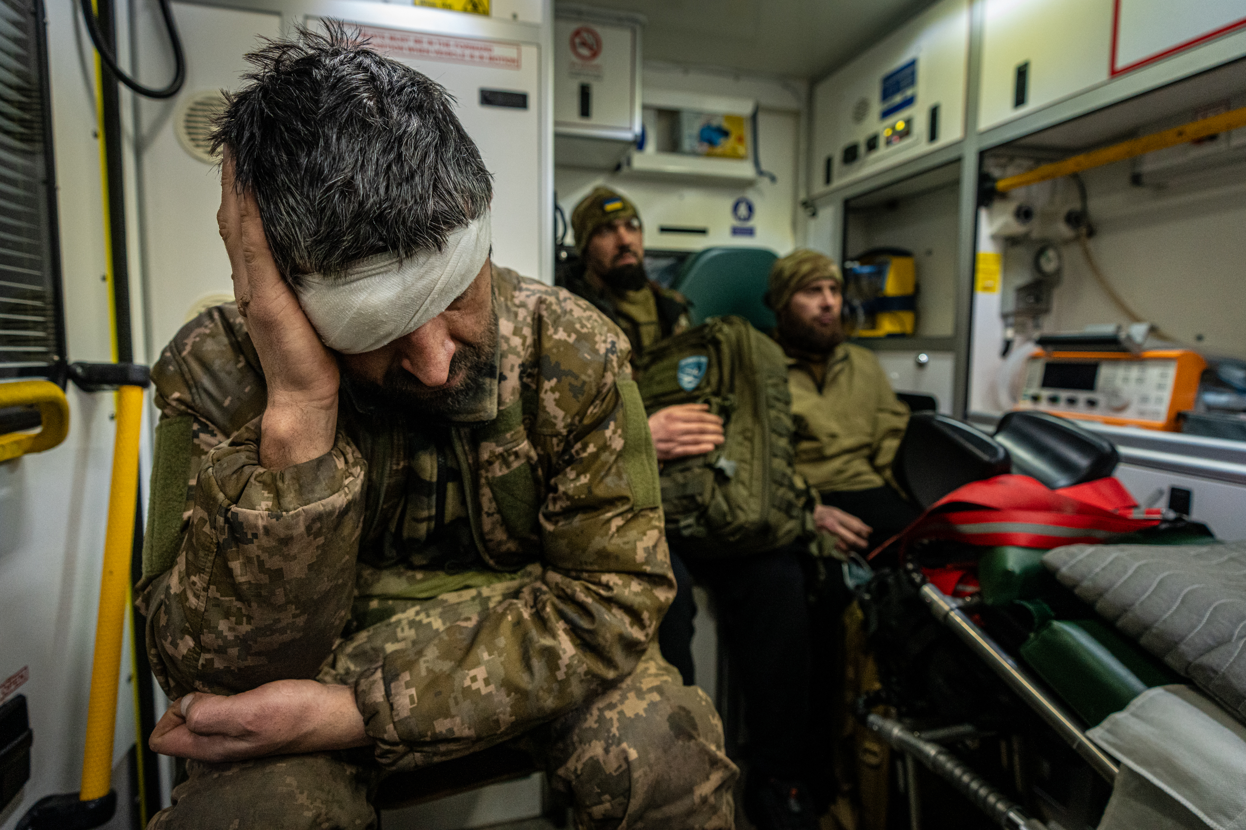 Ukrainian wounded soldiers are evacuated towards a hospital today as the bloody war of attrition grumbles on