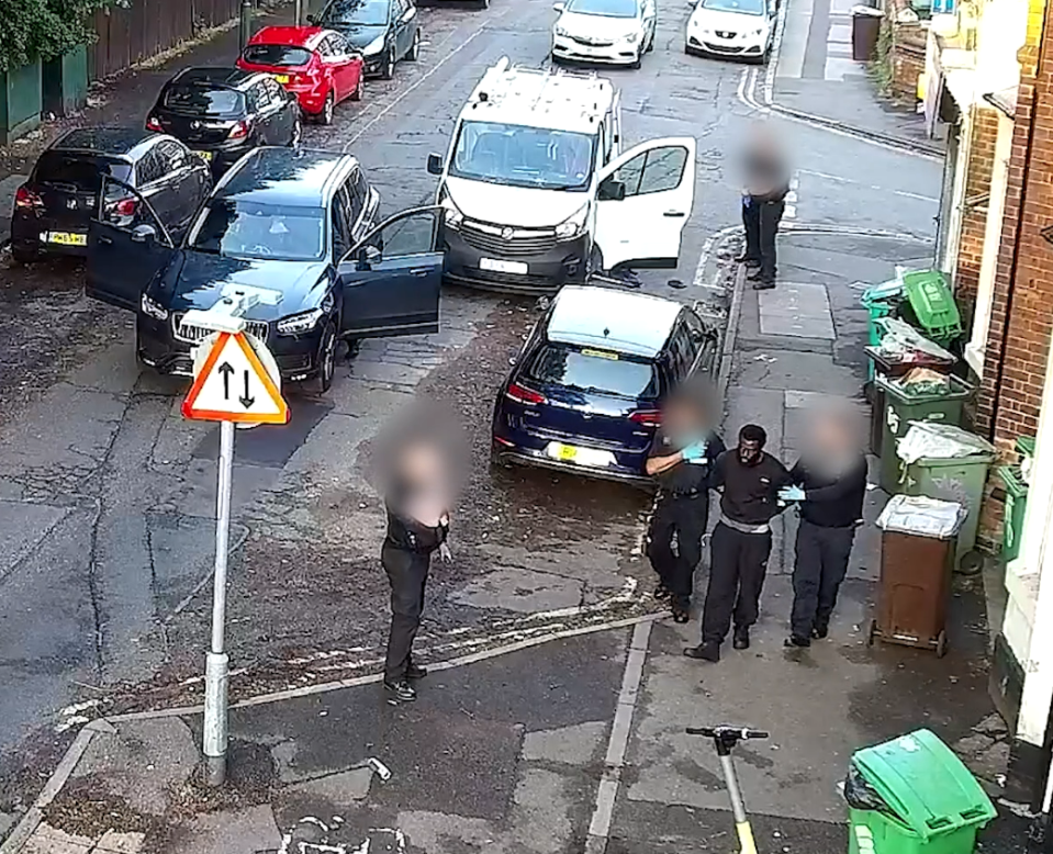 The thug is led away by officers in handcuffs