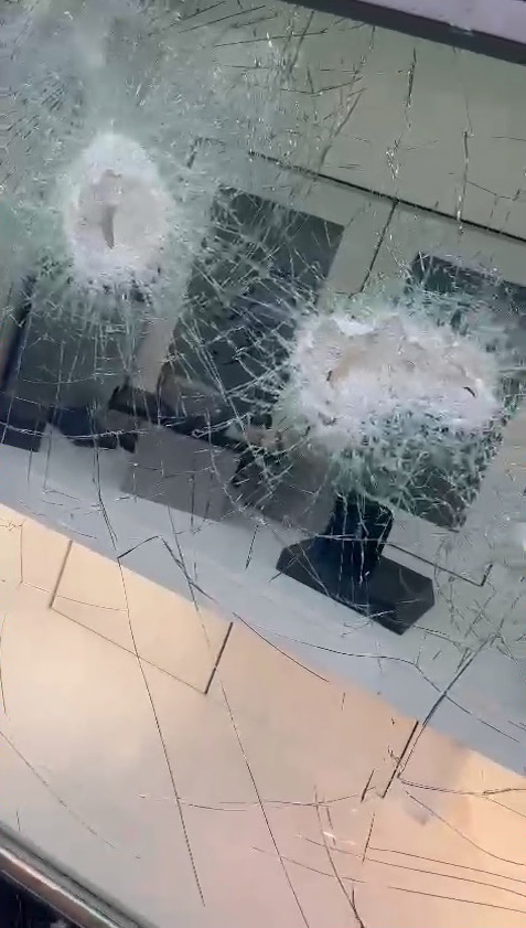 Security glass was battered with sledge hammers