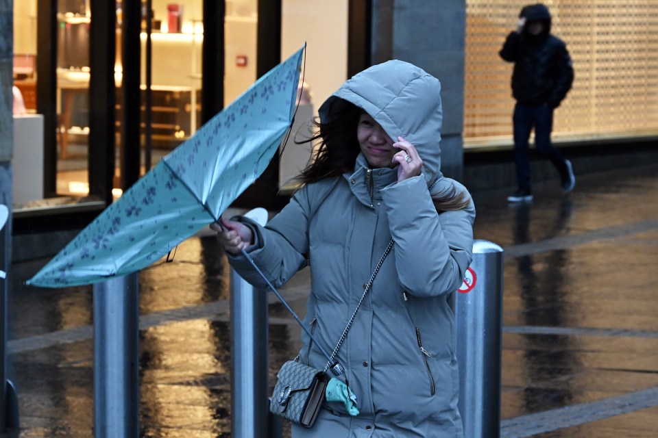 A woman braved the winds in Scotland's St Andrew Square today as Storm Jocelyn hit